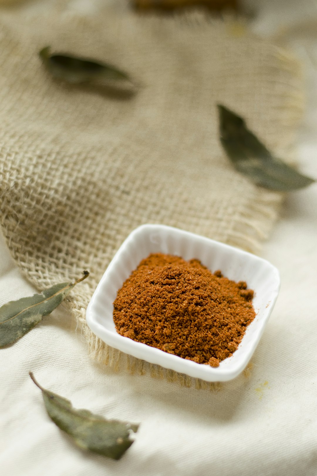 Fine yellow clay powder in a small white bowl