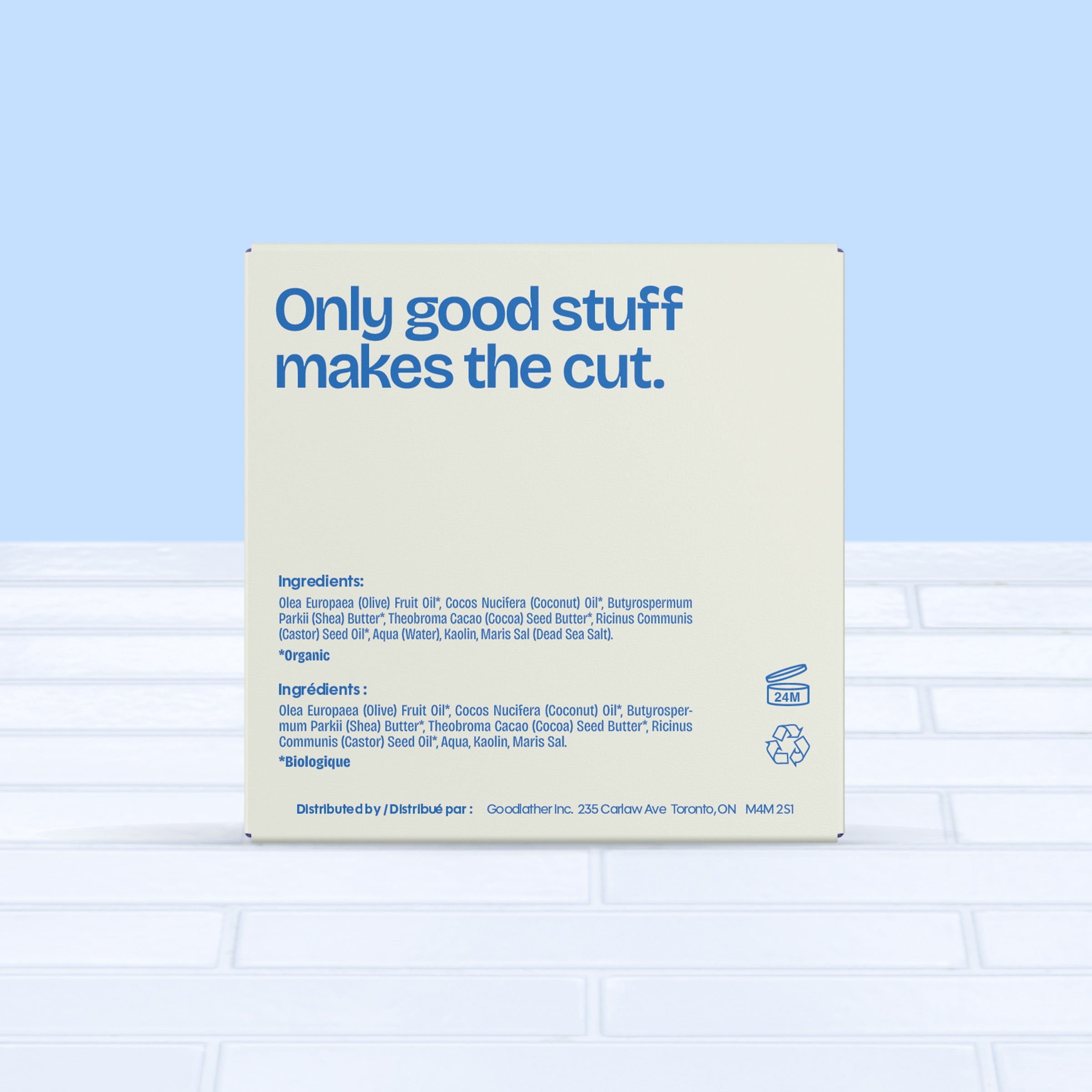 A 142g beige Goodlather Unscented Soap Bar box with blue text reads, "Only good stuff makes the cut." Made with natural ingredients for sensitive skin, it sits on white tile against a light blue background. Ingredients are listed below.